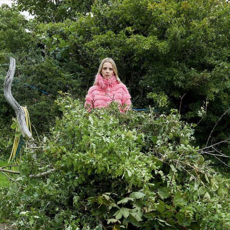 Image may contain: Plant, Outdoors, Clothing, Apparel, Animal, Bird, Tree, Human, Person, Garden, Vegetation, and Vase